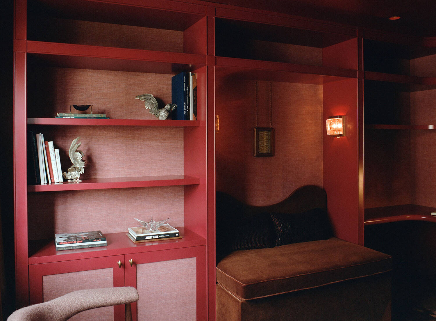 Library shelving with ceramics and lantern sconce