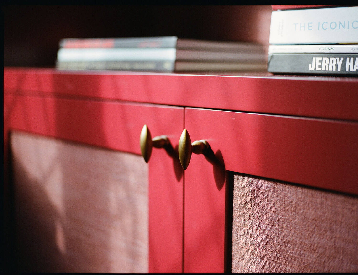 Brass hardware detail on lacquered cabinet doors