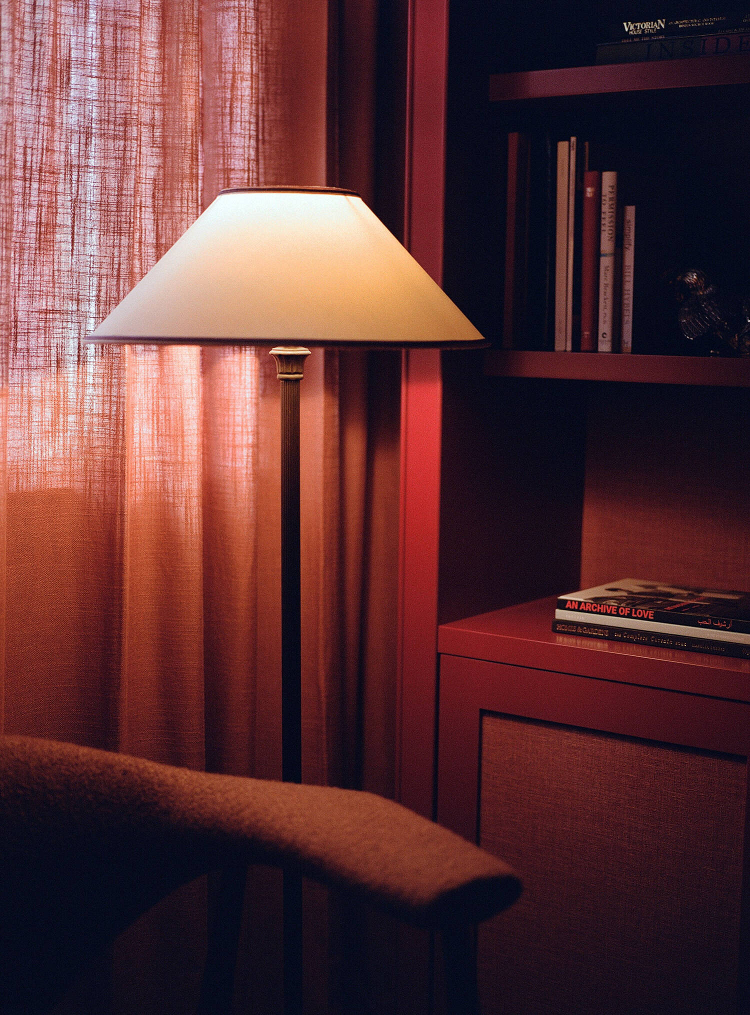 Coach House — table lamp against patterned curtain and red joinery