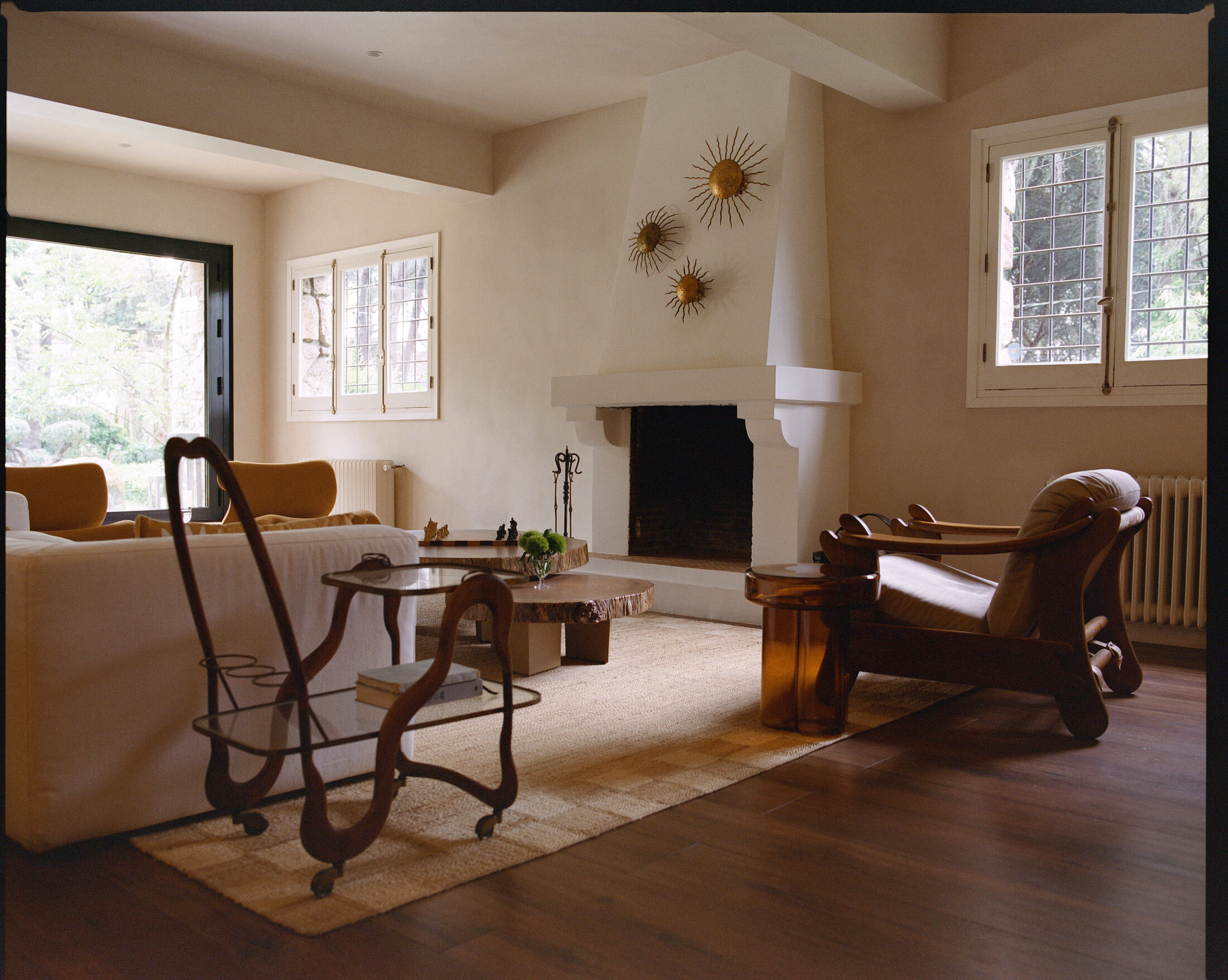 Lake House — living room with plaster fireplace and sculptural seating