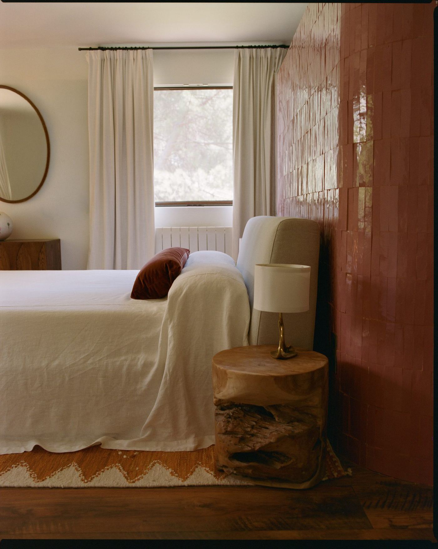 Bedroom with a draped chair beside a garden window