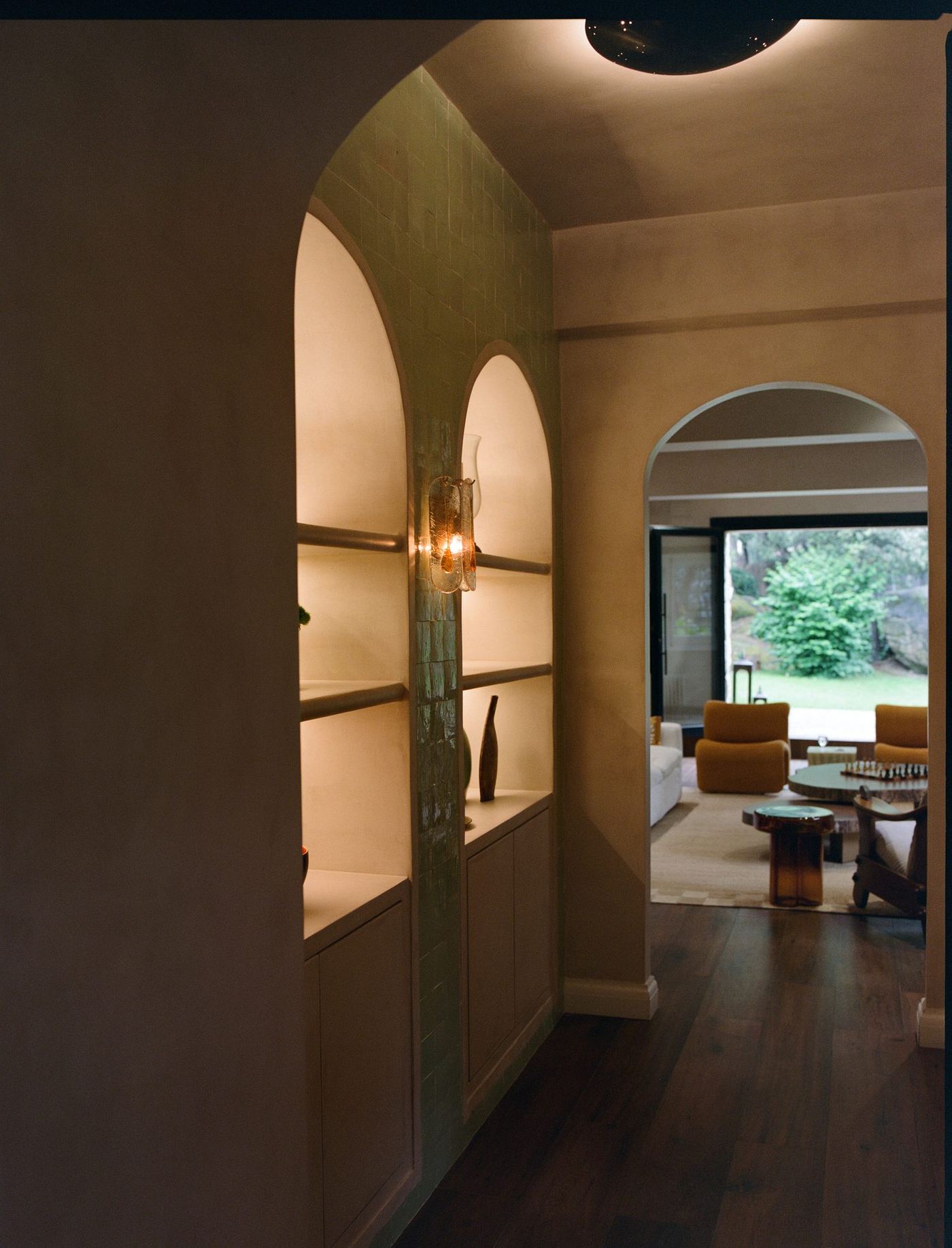 Arched plaster hallway opening to the living room